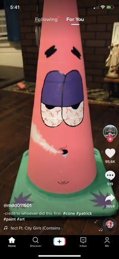 a pink cone with two faces on it