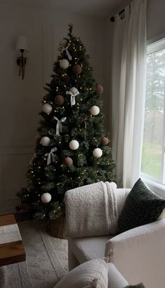 a living room with a christmas tree in the corner