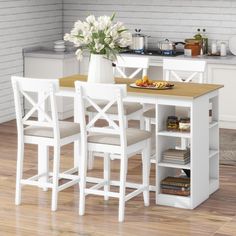 a white kitchen table with chairs around it