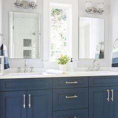 a bathroom with two sinks and mirrors in it