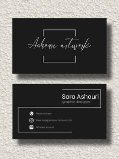 two black business cards with white writing on the front and bottom, one has a handwritten