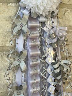 a bunch of ribbons that are on the side of a wall with flowers in them