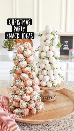 two christmas trees made out of donuts on a wooden platter with pink and white striped napkins