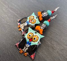 "Ahoy Matey!! These spooky little sweeties feature limited edition handmade enamel charms in the shape of little owls dressed up in their Vampire custome, complete with capes and bow ties! On top are ruffled pumpkin orange Lampwork discs and Lampwork rounds in clear with cool black scrollwork... almost looks like spiderwebs! Finished off with aqua Czech glass and blood red dots at the top. **One of a Kind, using limited edition components* Suspended from Sterling earwires. Length 2 1/2\" includi Whimsical Enamel Earrings Nickel Free, Playful Enamel Nickel-free Earrings, Playful Enamel Nickel Free Earrings, Playful Enamel Earrings Nickel Free, Playful Handmade Enamel Jewelry, Fun Enamel Earrings For Gifts, Cute Handmade Enamel Earrings, Vampire Custome, Little Owls