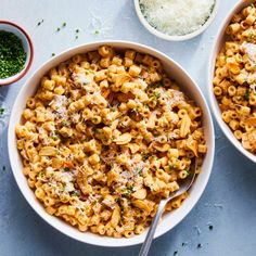 two bowls filled with pasta and parmesan cheese