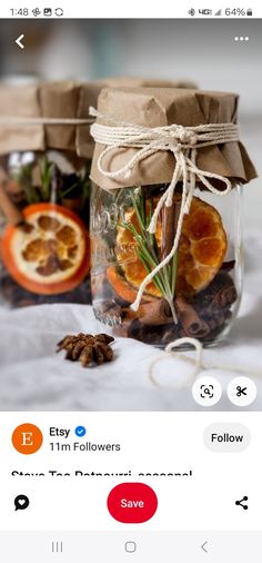 a jar filled with oranges and spices on top of a table