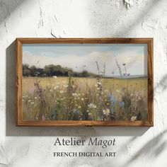 a painting hanging on the side of a white wall next to a wooden framed sign that reads atelier magot french digital art