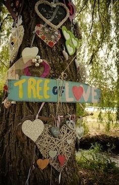 a tree decorated with heart shaped ornaments and a sign that says tree love on it