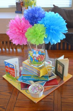 a table topped with lots of books and candy