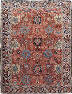 an antique persian rug with blue, red and orange colors on the bottom half of it