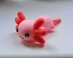 a pink toy laying on top of a white table