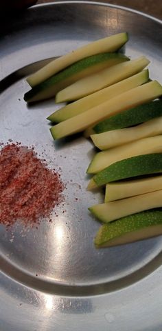 sliced up apples and spices on a metal plate