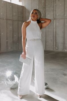 Jump into style our chic white 'Champagne On The Plane' jumpsuit featuring lightweight material, a halter neckline that buttons in the back, a sleeveless fit with an open back, a cinched waistline, and a relaxed pants silhouette that falls straight into ankle-length hemlines! Measurements XS : Bust 30", Hip 34", Inseam 30.5", Length 60", Waist 26". S : Bust 32", Hip 36", Inseam 31", Length 60.5", Waist 28". M : Bust 34", Hip 38", Inseam 31.5", Length 61", Waist 30". L : Bust 36", Hip 40", Inseam Backless Strapless Jumpsuit For Summer Formal, Summer Formal Backless Strapless Jumpsuit, Summer Formal Strapless Halter Neck Jumpsuit, Formal Strapless Halter Neck Jumpsuit For Summer, White Strapless Jumpsuit For Summer Nights, White Strapless Jumpsuit For Evening, White Strapless Jumpsuit For Night Out In Summer, Elegant White Strapless Jumpsuit For Party, Chic Sleeveless Jumpsuits And Rompers For Wedding