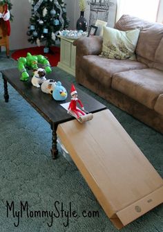 a living room filled with lots of furniture and christmas decorations on top of a coffee table