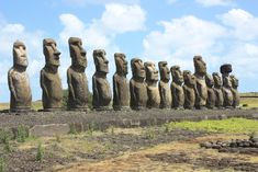 a row of moai statues in the middle of nowhere