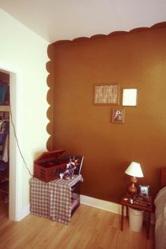 a bedroom with brown walls and wooden floors