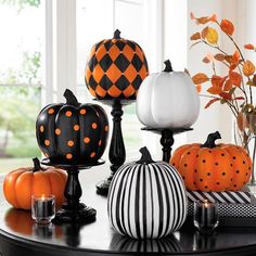 pumpkins and gourds are sitting on a table