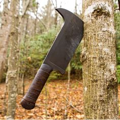 a large knife stuck in the side of a tree