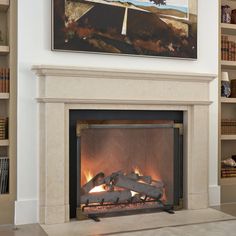 a fire place with a painting on the wall