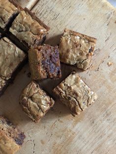 brownies cut into squares sitting on top of a wooden cutting board