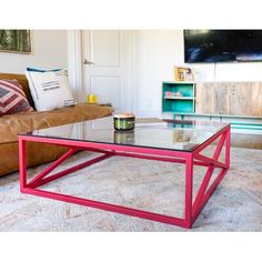 a living room with a couch, coffee table and bookshelf in the background