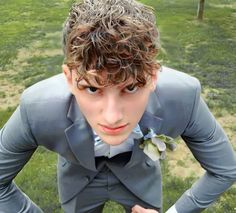 a young man in a suit and bow tie