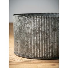 a metal container sitting on top of a wooden table