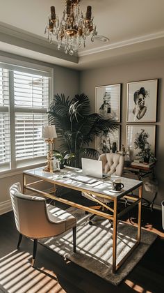 a living room filled with furniture and a chandelier above a glass top table