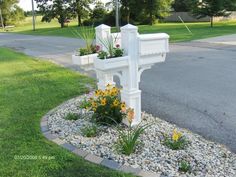 a white mailbox with flowers growing out of it