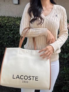 Lacoste Unisex Canvas Tote Natural Tan NU4342TD K02A tote - but a sophisticated tote. Made from an elegant canvas fabric, a nod to Lacoste's iconic tennis style. Result: A generously-proportioned bag that'll hold your essentials in style. Dimensions : L15.7 x H11.6 x D7" / L40 x H29.5 x D18 cm Cotton outer 45 cm / 18" handles 1 zipped inside pocket Large enough to fit your 17" laptop Outside : Cotton (100%) Casual White Canvas Bag With Leather Handles, Casual Canvas Bag With Leather Handles For Weekend, White Casual Canvas Bag For Weekend, Casual Cream Canvas Bag With Leather Handles, Casual White Canvas Bag For Weekend, Casual White Shoulder Bag With Canvas Lining, Weekend Canvas Tote Bag, Casual Beige Canvas Bag For Weekend, Casual Beige Shoulder Bag For Weekend