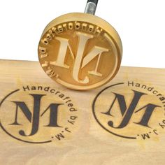 two wooden stamps with the letters n and n on them