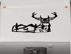 a deer with antlers is shown on the side of a vehicle's rear window