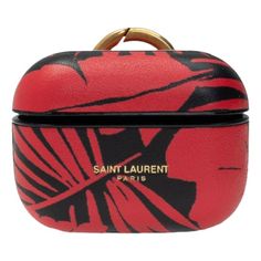 Add a touch of luxury to your daily accessories with this abstract Saint Laurent black and red airpods pro case. This sleek leather case offers a snug fit to ensure your airpods will stay secure along with protecting them from scratches, drops, and dust. This case includes a keyring making it the perfect accessory for working out, traveling, business meetings, and more.    Model: 641954  Material: Leather  Hard case for Airpods Pro  Abstract red/black pattern  Gold-tone hardware  Black interior Red Airpods, Keyring Making, Daily Accessories, Paris Logo, Airpods Pro Case, Headphone Accessories, Front Face, Gold Clips, Saint Laurent Paris