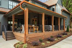 a large house with lots of windows on the front and side of it's porch