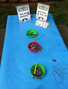 the table is set up with crayons, pencils and markers for kids to draw