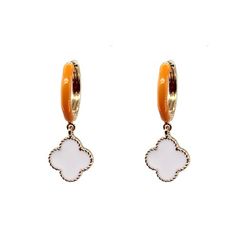 Score a style touchdown with these Clover Dangle Earrings! Featuring a 1 1/2 inch orange enamel huggie earring with a white clover dangle, these earrings are perfect for adding a touch of fun and energy to your gameday outfit. Show off your Volunteer pride in these stylish and classic earrings. 1 1/2in ORANGE ENAMEL HUGGIE EARRING WITH WHITE CLOVER DANGLE Trendy Hypoallergenic Enamel Earrings, Trendy Small Hoop Orange Jewelry, Trendy White Enamel Earrings, White Enamel Small Hoop Earrings, Trendy Enamel Drop Earrings, Trendy White Small Hoop Earrings, White Hypoallergenic Enamel Earrings, Trendy White Enamel Jewelry, Hypoallergenic White Enamel Earrings