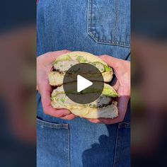 a person holding a sandwich in their hands with the video showing how to make it