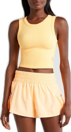 Functional Seamless Tank Top For Summer, Trendy Cropped Tank Top For Gym, Yellow Stretch Sleeveless Activewear, Yellow Ribbed Sleeveless Tank Top, Summer Sports Ribbed Crop Top, Ribbed Crop Top For Gym In Spring, Versatile Sleeveless Seamless Crop Top, Spring Ribbed Crop Top For Gym, Versatile Sleeveless Crop Top With Seamless Construction