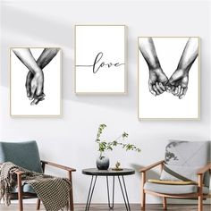 two black and white prints with hands holding each other's fingers on the wall