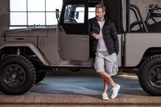 a man standing in front of a jeep