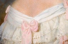 the back of a woman's white dress with pink bows