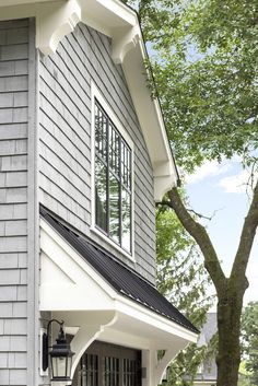 a gray house with white trim and black shutters