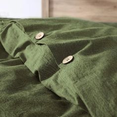 a green blanket with two buttons on it