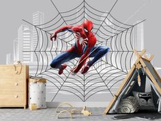 a spiderman wall mural in a child's room with a teepee tent