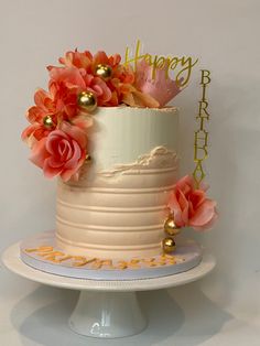 a birthday cake decorated with flowers on a plate