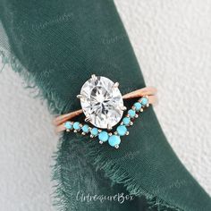 a diamond ring with turquoise stones on it