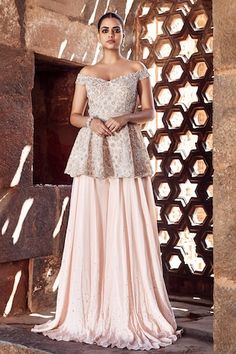 Blush pink peplum top with silver dori, pearl, mirror and sequin embroidery in floral pattern. Paired with sharara and belt. - Aza Fashions Pink Floor-length Sharara With Ruffles, Pink Ruffled Choli For Wedding, Traditional Pink Peplum Dresses, Fitted Pink Sharara With Ruffles, Traditional Pink Peplum Sharara, Pink Fitted Sharara With Ruffles, Pink Peplum Set With Resham Embroidery, Elegant Pink Peplum Sharara, Pink Peplum Sets For Wedding