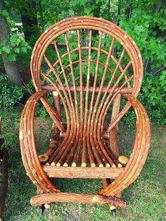 a wooden chair made out of branches in the grass