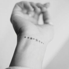 a woman's wrist with stars on it and the word star written in black ink