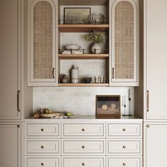 a kitchen with white cabinets and gold knobs on the doors, drawers and cupboards